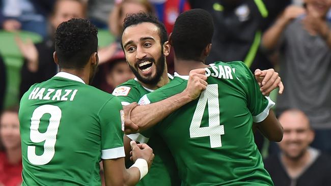 Mohammed Al Sahlawi of Saudi Arabia (C) celebrates after scoring a goal with Naif Hazazi (L) and Abdulla Aldossary (R) during the Group B Asian Cup football match between North Korea and Saudi Arabia in Melbourne on January 14, 2015. AFP PHOTO / MAL FAIRCLOUGH -- IMAGE RESTRICTED TO EDITORIAL USE - STRICTLY NO COMMERCIAL USE