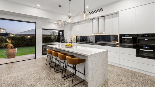 The kitchen has Caesarstone benchtops and space for guests to perch.