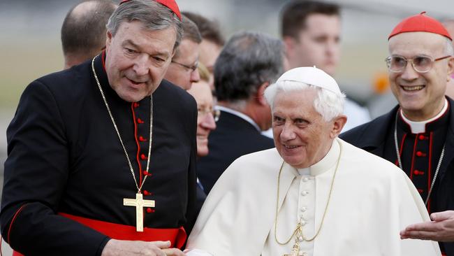 Pope Benedict XVI, right, is greeted by Cardinal George Pell, left, on his arrival in Sydney, 2008., Benedict is in Australia for the July 15-20 World Youth Day festival. (AP Photo/Mark Baker)