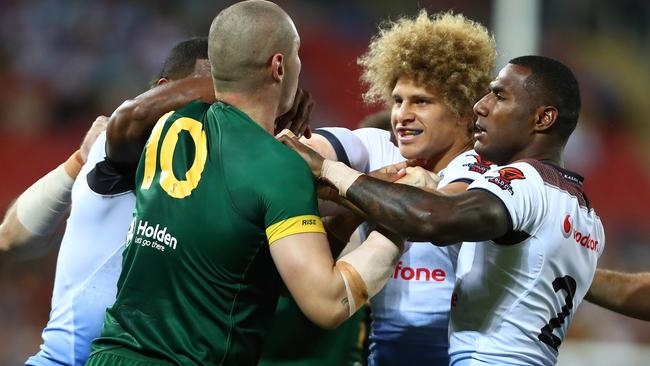 Players grapple during World Cup semi-final match between Australian and Fiji.