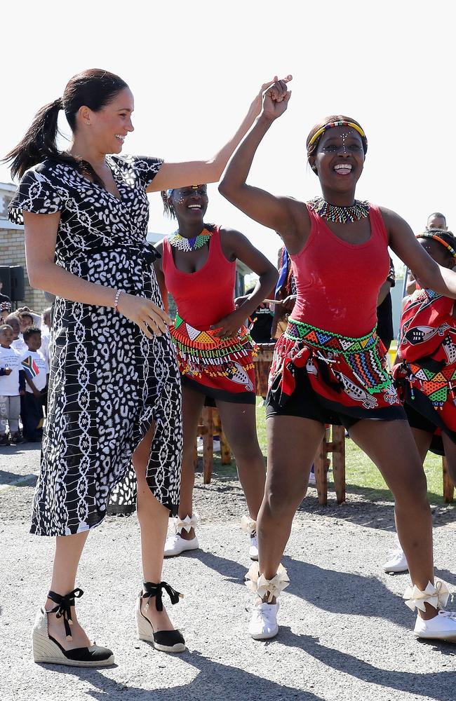 Meghan gets into the groove during the fun visit. Picture: Chris Jackson/Getty Images