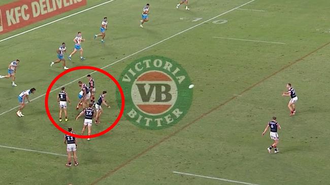 The Roosters form a wall as Sam Walker kicks a field goal.