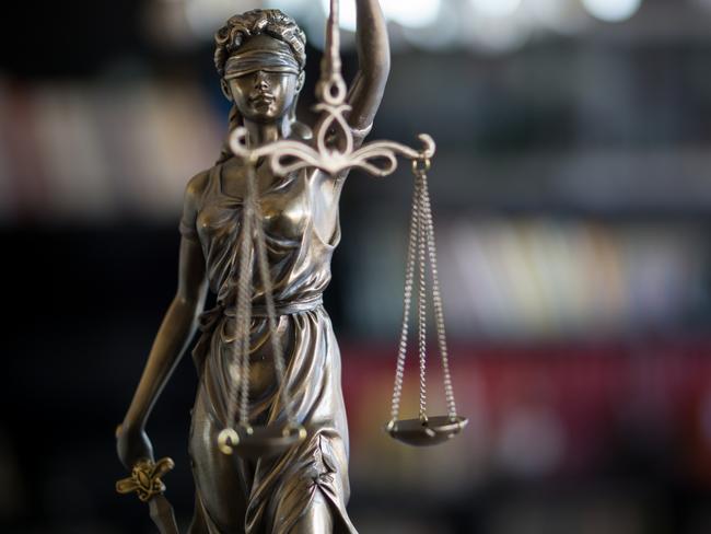 Statue of Justice with scales in lawyer office. Legal law, advice and justice concept. Istock