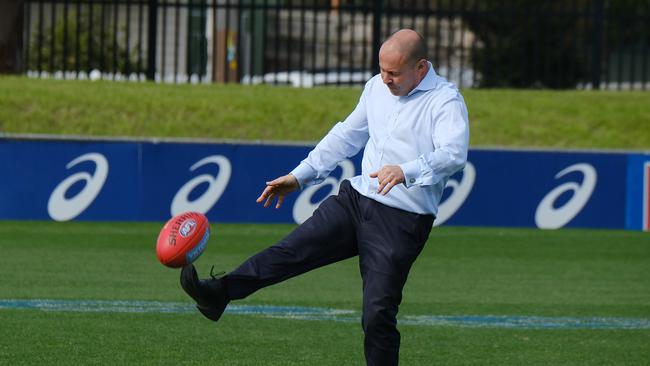 Frydenberg kicks the footy after giving a media conference at Whitten Oval. Picture: NCA NewsWire / Luis Enrique Ascui