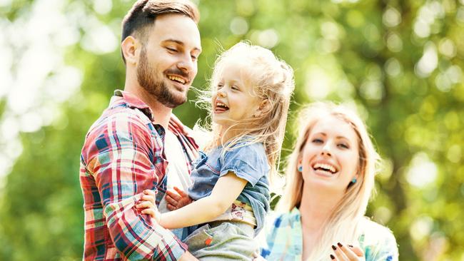 Happy family of three enjoying sunny day in the park; life insurance generic mum dad and child