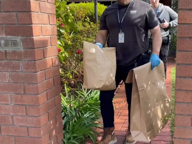 Police remove evidence after the Malvern East raid.