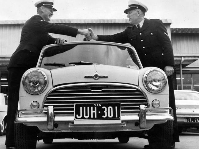 1967: First Constable R.E. Westwater (left) and First Constable J.E. Bathard shake hands as they take delivery of one of two new Mini-Cooper patrol cars — dubbed the Peanut Patrol — for the Mobile Traffic Branch in Victoria. File picture