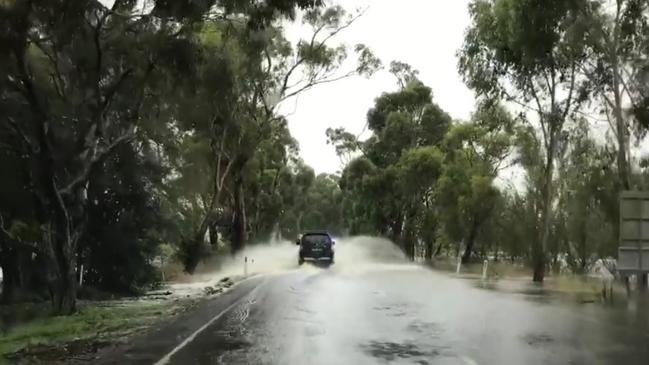 The SES reminds people never to drive through flooded water, unlike this driver near Burrawang. Picture: Phillip Minnis