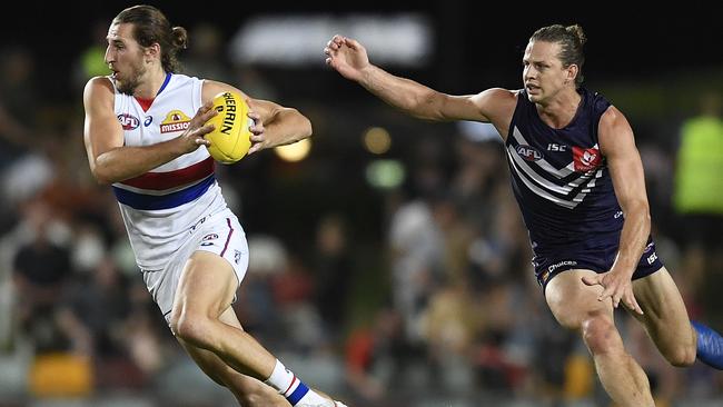 Marcus Bontempelli breaks away from Dockers captain Nat Fyfe.