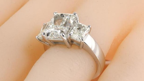 A diamond trilogy ring with a combined seven carats of sparkle is expected to fetch about $66,000. Picture: State Auctions