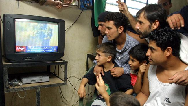 Palestinians watch the news at the Palestinian refugee camp of Burg al-Barajneh in Beirut.