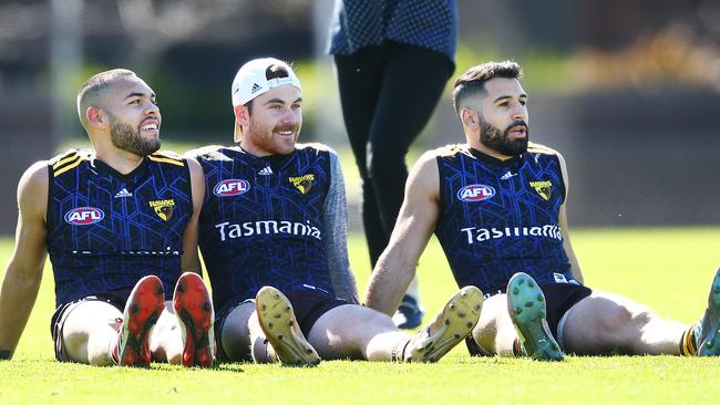 Paul Puopolo (right) relaxes at Hawks training on Wednesday with teammates Jarman Impey and Teia Miles. Pic: Getty Images