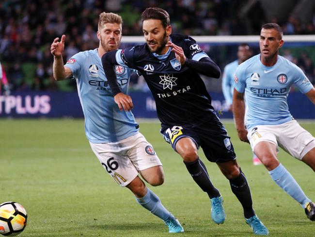 Sydney FC’s Milos Ninkovic takes on Melbourne City’s Luke Brattan.