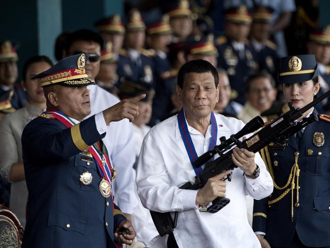 Philippine President Rodrigo Duterte holds a Galil sniper rifle. Picture: AFP