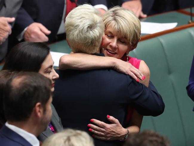 Julie Bishop hugs Kerryn Phelps after her swearing in, at the House of Representatives in Parliament House in Canberra today. Picture: Kym Smith