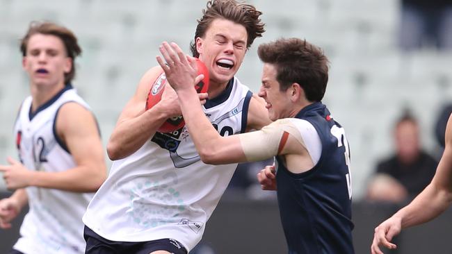 Oscar Brownless tries to charge through the tackle of Zak Butters. Pic: Michael Klein