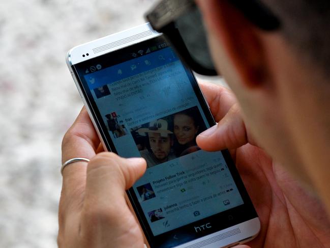 A man uses Twitter from his mobile phone in Havana, on March 17, 2019. - A new civil society emerges in Cuba with mobile phones having internet, defying six decades of unanimity. (Photo by YAMIL LAGE / AFP)