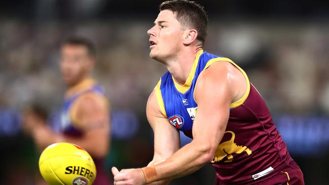 BRISBANE, AUSTRALIA - MARCH 19: Dayne Zorko of the Lions handballs during the round one AFL match between the Brisbane Lions and the Port Adelaide Power at The Gabba on March 19, 2022 in Brisbane, Australia. (Photo by Chris Hyde/Getty Images)