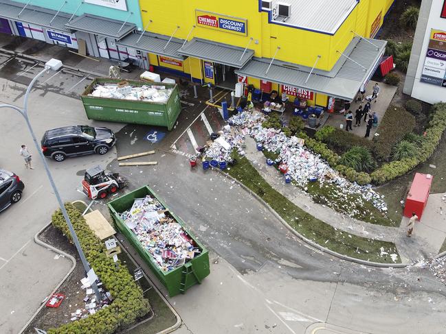 Staff work to clean up flood damage at a Chemist Warehouse at Windsor in Brisbane. Picture: Peter Wallis / Getty Images