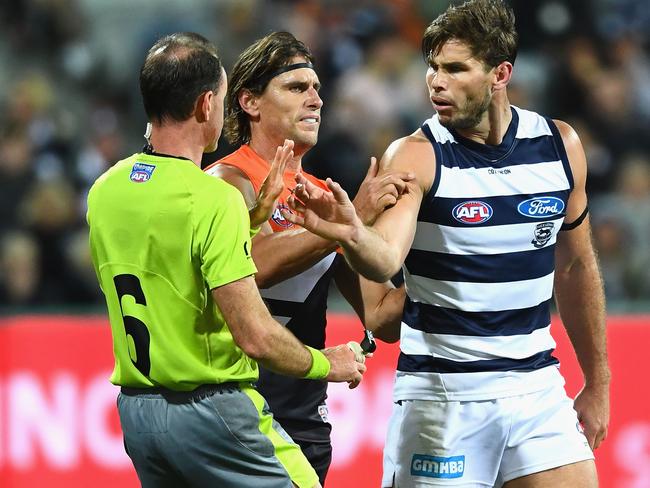 Tom Hawkins of the Cats argues with the umpire after an incident with Nick Haynes