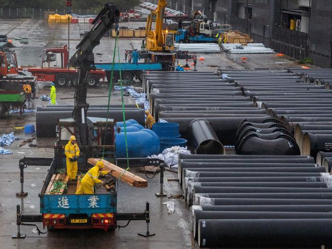 Construction crew work at the site of a temporary isolation facility to house Covid-19 coronavirus patients at Kai Tak in Hong Kong on February 20. Picture: AFP