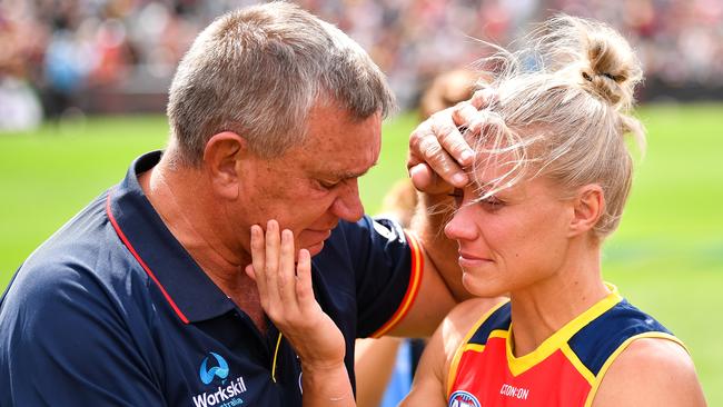 Greg Phillips, former footballer and father of Erin Phillips, give his daughter a hug after her knee injury. Pic: Getty Images