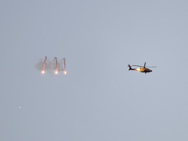 An Israeli army helicopter firing flares above the Gaza Strip. Picture: AFP