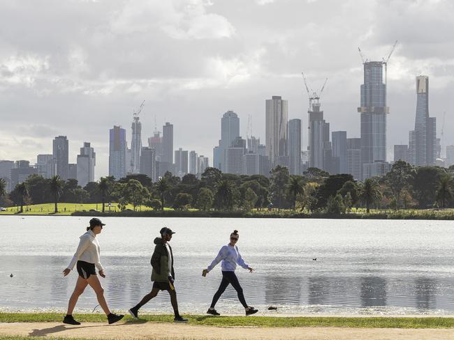 MELBOURNE, AUSTRALIA - MAY 13: People walk around Albert Park Lake on May 13, 2020 in Melbourne, Australia. COVID-19 restrictions have eased slightly for Victorians in response to Australia's declining coronavirus (COVID-19) infection rate. From today, people in Victoria will be allowed to visit friends and family. A maximum gathering of up to ten outdoors is allowed, or up to five visitors inside a home. Golfing, hiking and fishing is also now permitted. (Photo by Daniel Pockett/Getty Images)