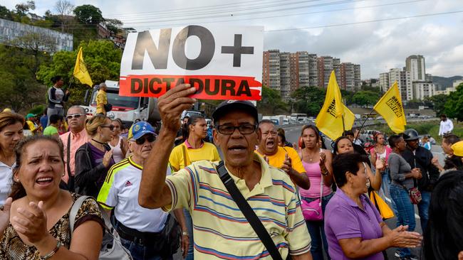 Venezuelan opposition activists march along a street in Caracas chanting slogans against the government of President Nicolas Maduro. Picture: AFP