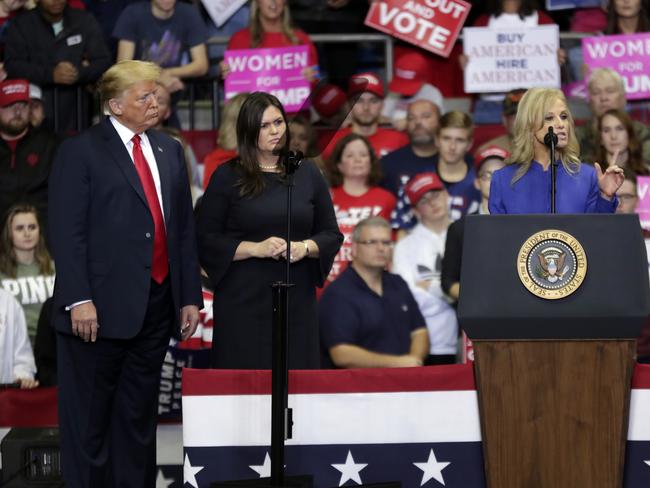 Donald Trump and press secretary Sarah Huckabee Sanders listen as White House senior adviser Kellyanne Conway speaks at a campaign rally at the Allen County War Memorial Coliseum in Fort Wayne. Picture: AP