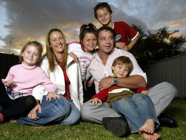 Mark Geyer relaxes with wife Meagan and children (from left) Kennedi, Montanna, Mavrik and Logan 9 at their South Penrith home in 2004. Picture: Marc McCormack