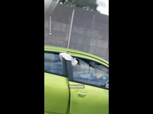 A Melbourne driver holds his door shut with a towel