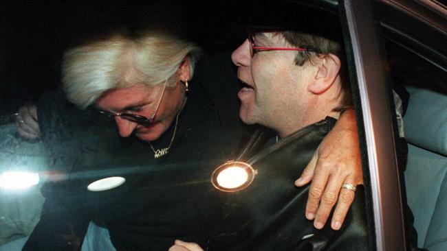 Publicist Patti Mostyn in a car with singer Elton John after his arrival in Melbourne for gig at the opening of the famous Crown Casino, Melbourne in 1997. Picture: John/Singer