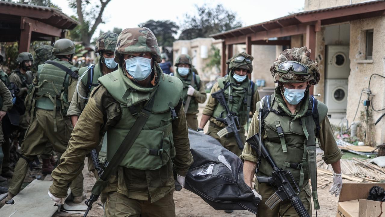 Israeli forces extracting dead bodies of residents from a destroyed house. Picture: Supplied