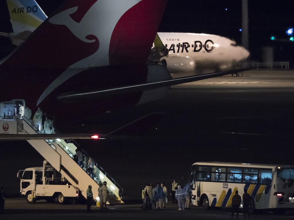 Passengers board the Qantas aircraft chartered by the Australian government after disembarking from the quarantined Diamond Princess cruise ship at Haneda airport on February 19, 2020 in Tokyo, Japan. Picture: Tomohiro Ohsumi/Getty Images