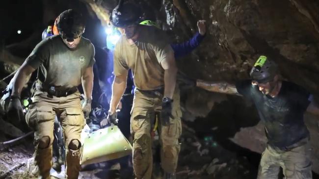 Rescue personnel carrying a member of the "Wild Boars" Thai youth football team on a stretcher during the rescue operation inside the Tham Luang cave. Picture: AFP/Royal Thai Navy