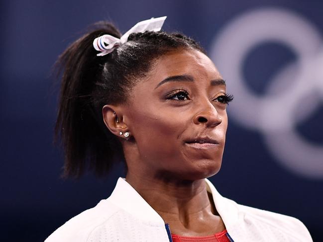 TOPSHOT - USA's Simone Biles cheers during the artistic gymnastics women's team final during the Tokyo 2020 Olympic Games at the Ariake Gymnastics Centre in Tokyo on July 27, 2021. (Photo by Loic VENANCE / AFP)