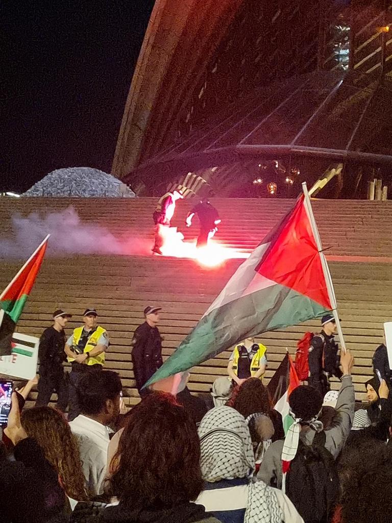 Flares were thrown at police, who scurried to try and put them out. Picture: News.com.au / Jasmine Kazlauskas