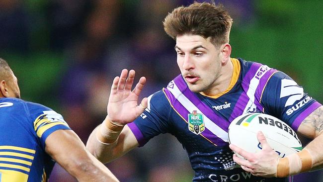 MELBOURNE, AUSTRALIA — AUGUST 17: Curtis Scott of the Storm runs with the ball from Michael Jennings of the Eels during the round 23 NRL match between the Melbourne Storm and the Parramatta Eels at AAMI Park on August 17, 2018 in Melbourne, Australia. (Photo by Michael Dodge/Getty Images)