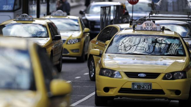 Generic and stock images around Melbourne CBD. Taxi rank, taxis with tram in background - Black Cabs