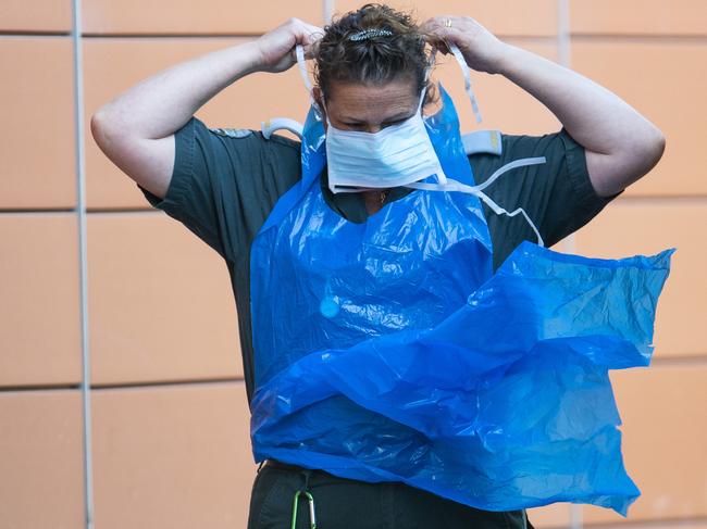 An ambulance worker puts on a protective mask outside the Royal London Hospital. Picture: Getty Images