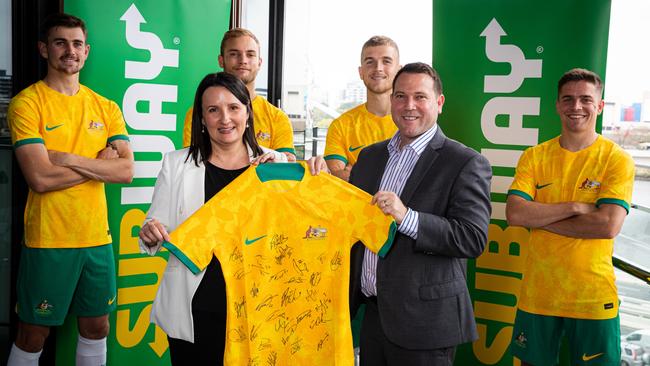 Subway marketing director Rodica Titeica and Football Australia CEO James Johnson with Socceroos players.