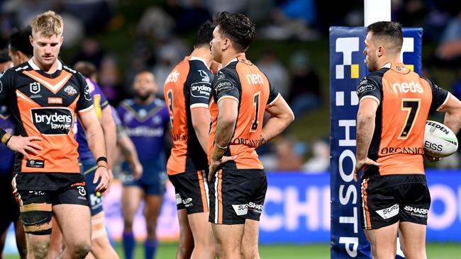 Luke Garner, Daine Laurie and Luke Brooks of the Tigers dejected after a try by Jahrome Hughes (Photo by Bradley Kanaris/Getty Images)