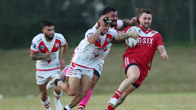 The Woy Woy defence wrapping up Kincumber’s Curtis Naughton. Picture: Sue Graham