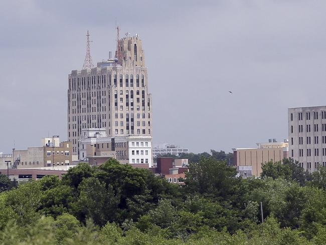 In a June 12, 2014 photo in Flint, Mich., the skyline of the city is seen from the west side. As Detroit hopes to ride out of bankruptcy this year, a smaller Michigan city with a similarly strong bond to the automotive industry soon could drive in. Flint, like its bankrupt big brother an hour’s drive south, has suffered a spectacular drop in population and factory jobs with a corresponding rise in property abandonment and crime. (AP Photo/Carlos Osorio)