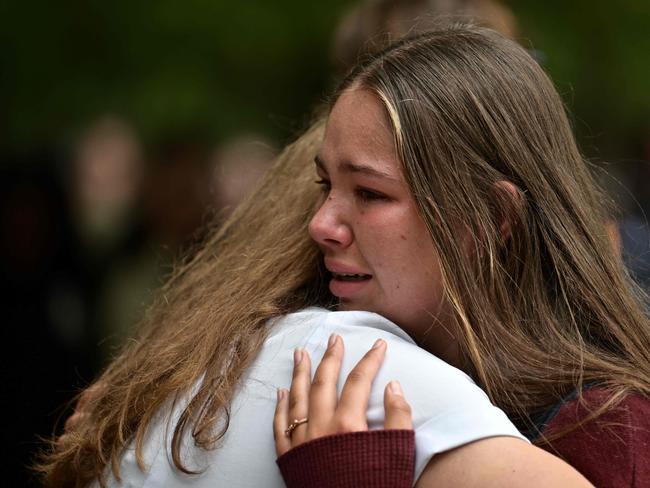 Students comfort each other during a vigil in Christchurch. Picture: AFP 