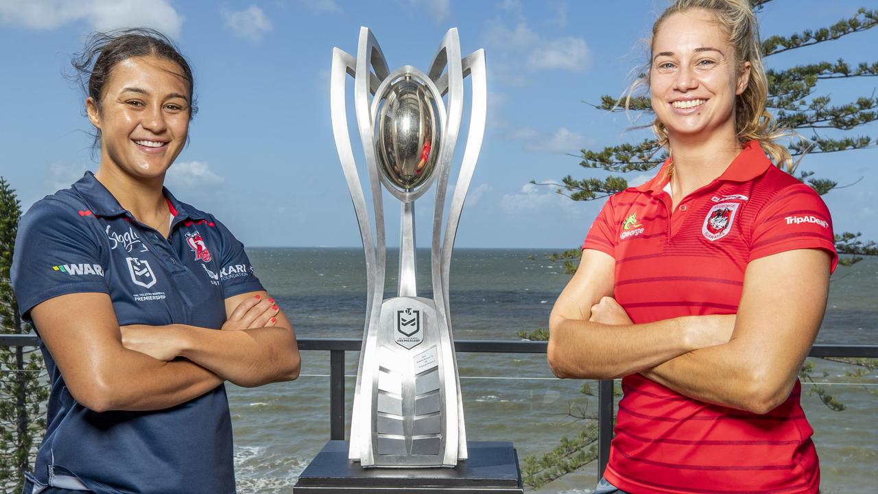 Roosters’ Corban Baxter and Dragons opposite Kezie Apps with the NRLW trophy. Picture: Richard Walker
