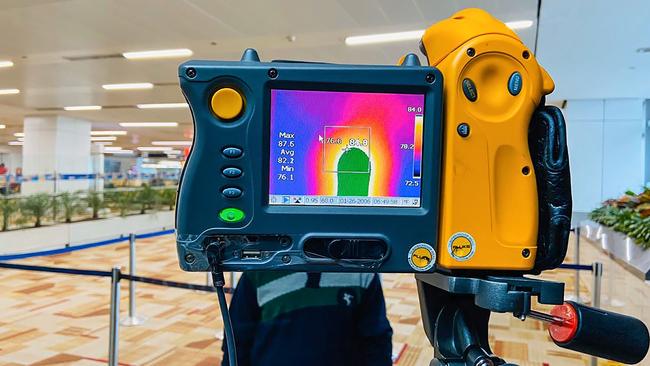 A thermographic camera screens the head of a man at Indira Gandhi International Airport in New Delhi.