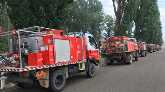 A line of fire trucks stretches out in Taralga. Pic: Warren Brown.