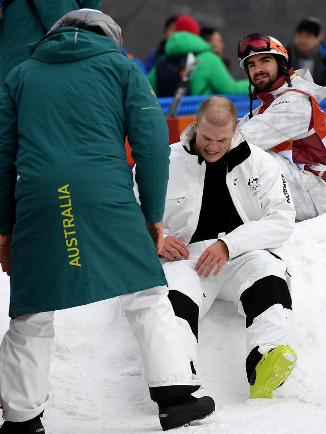 Brodie Summers of Australia holds his knee after sustaining an injury in practice on Friday. Photo: AAP